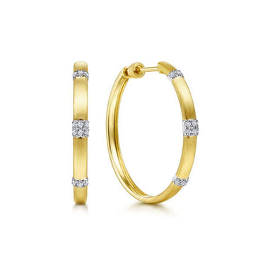Yellow gold hoop earrings with diamond accents, matte finish, elegant jewelry design
