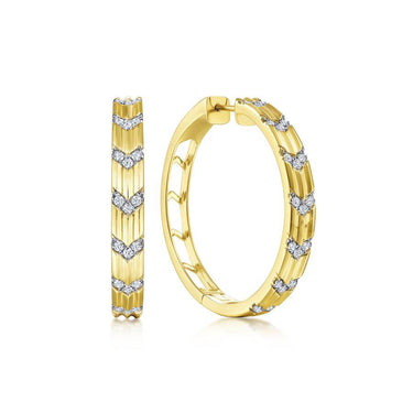 Yellow gold hoop earrings with chevron diamond accents on a white background