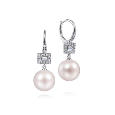 White gold drop earrings with round pearls and diamond accents on a white background