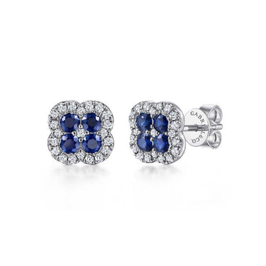 White gold stud earrings with blue sapphires and diamond halo in a floral design