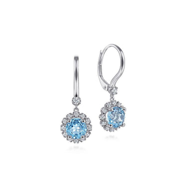 White gold drop earrings with round blue gemstones and diamond halo accents