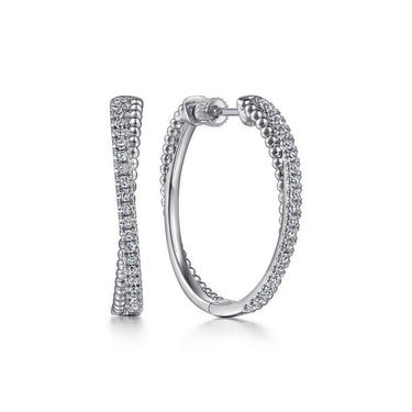 White gold diamond hoop earrings with beaded detailing on white background