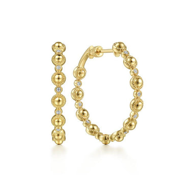 Yellow gold beaded hoop earrings with round diamond accents on white background