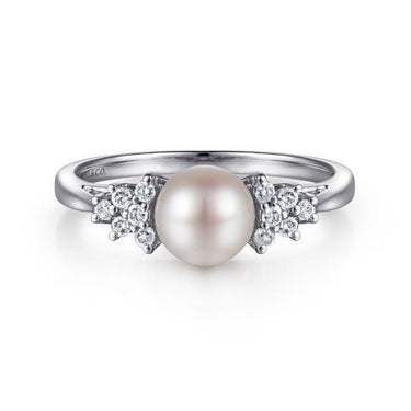 White gold ring with round pearl center and cluster diamond accents
