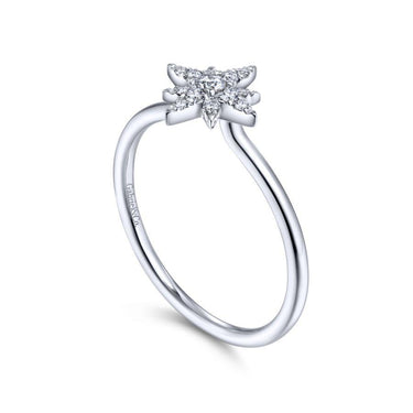 White gold engagement ring with a star-shaped diamond cluster setting on clean background