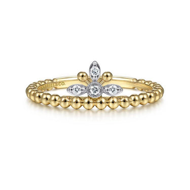 Gold beaded band ring with floral diamond cluster on white background.