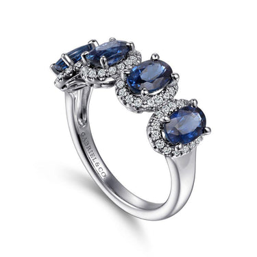 White gold ring with oval blue sapphires and diamond halos, elegant fine jewelry