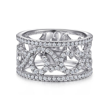 Wide diamond band ring with intricate scrollwork and pavé setting on white background