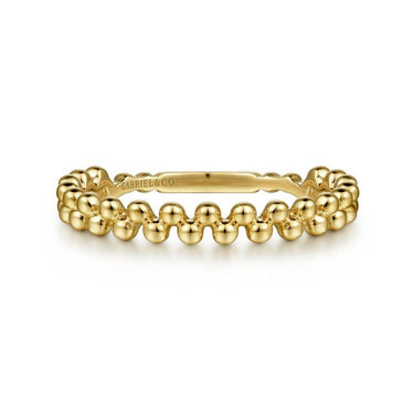 Yellow gold beaded stackable ring with polished finish on white background
