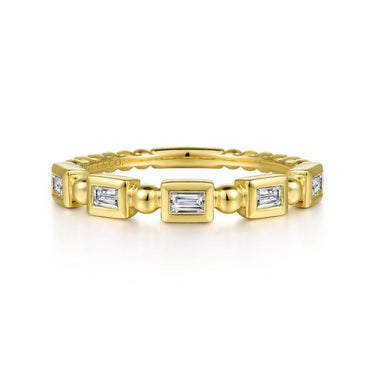 Yellow gold ring with rectangular baguette-cut diamonds in a geometric setting on a white background.