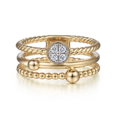 Stackable yellow gold rings with diamond cluster center and beaded detailing