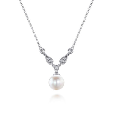 White gold necklace with round pearl pendant and diamond accents