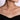 Woman wearing a V-shaped diamond pendant necklace on a delicate chain