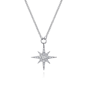 White gold starburst pendant necklace with diamond accents on a fine chain