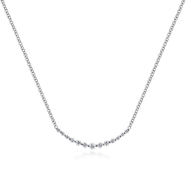White gold necklace with a curved row of round diamonds on a simple chain, minimalist design