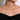 Woman wearing a delicate diamond bar necklace on a thin chain