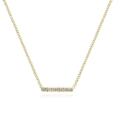 Yellow gold necklace with a horizontal diamond bar pendant on a plain white background