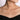 Woman wearing a delicate gold bar diamond necklace against bare neckline