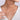 Woman wearing a delicate V-shaped diamond necklace with white gold chain on bare neck