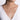 Woman wearing a white gold diamond halo pendant necklace with a round center stone