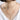 Layered gold necklace with two delicate pendants on a woman wearing a white top