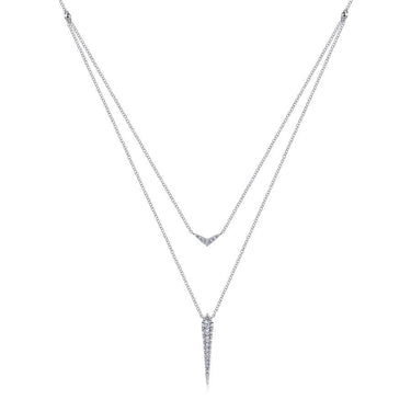 Layered white gold necklace with diamond V-shaped and spike pendants on white background