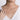 Woman wearing delicate white gold diamond pendant necklace on a thin chain