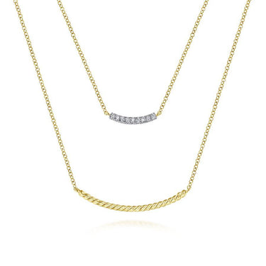 Layered gold necklace with diamond bar and twisted gold bar design on white background