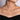 Layered gold chain necklaces with curved bar pendants on woman's neck