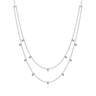 Double strand white gold necklace with bezel set round diamonds on a white background.