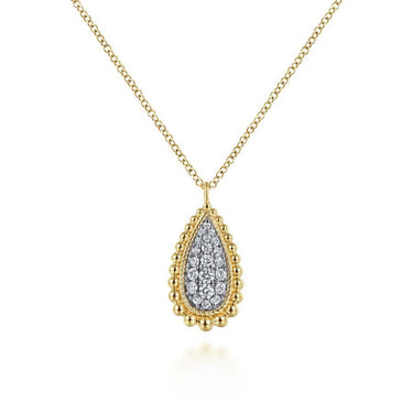 Gold chain necklace with teardrop diamond pendant, intricate beaded edge design