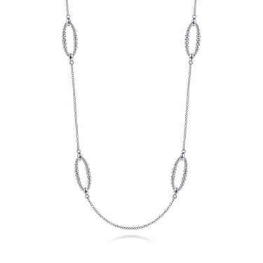 Sterling silver beaded chain necklace with oval stations on white background