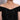 Long silver chain necklace with oval diamond stations on a woman wearing a black off-shoulder top